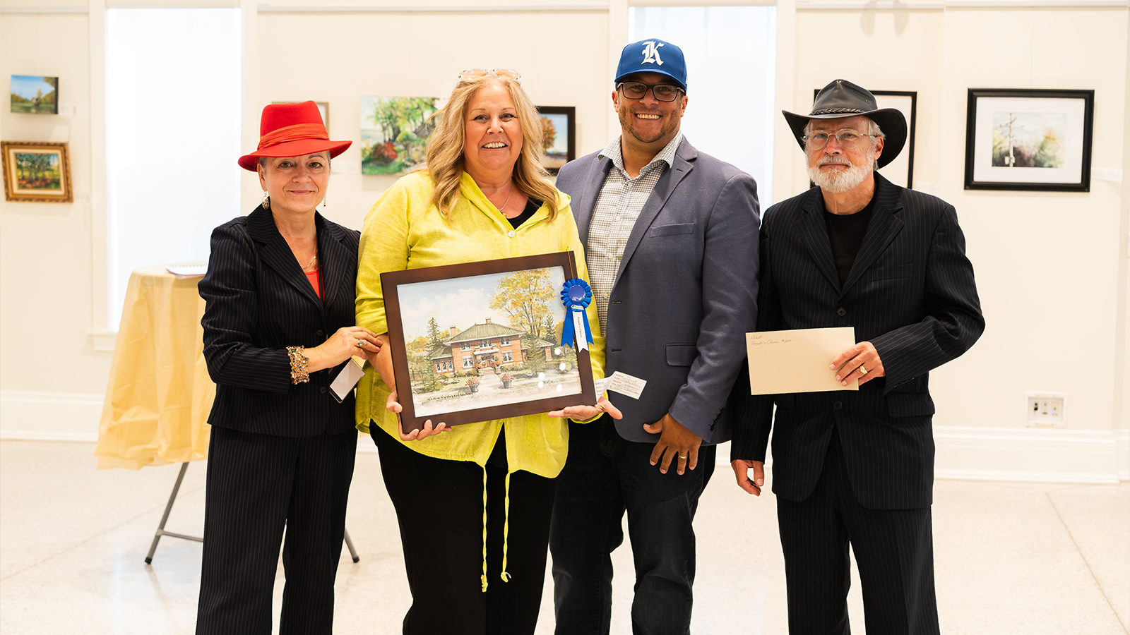 Sandra Ellis accepting their award with the Mayor Dennis Rogers and Layne Van Loo