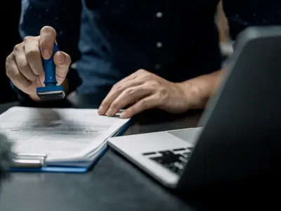 Man stamps an application form