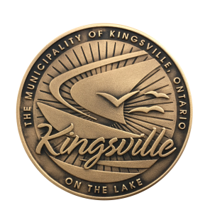 Back of collector coin showing a sailboat with the words Kingsville on the Lake