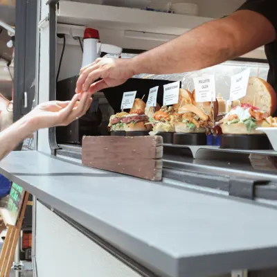 Money exchange between a food truck worker and patron