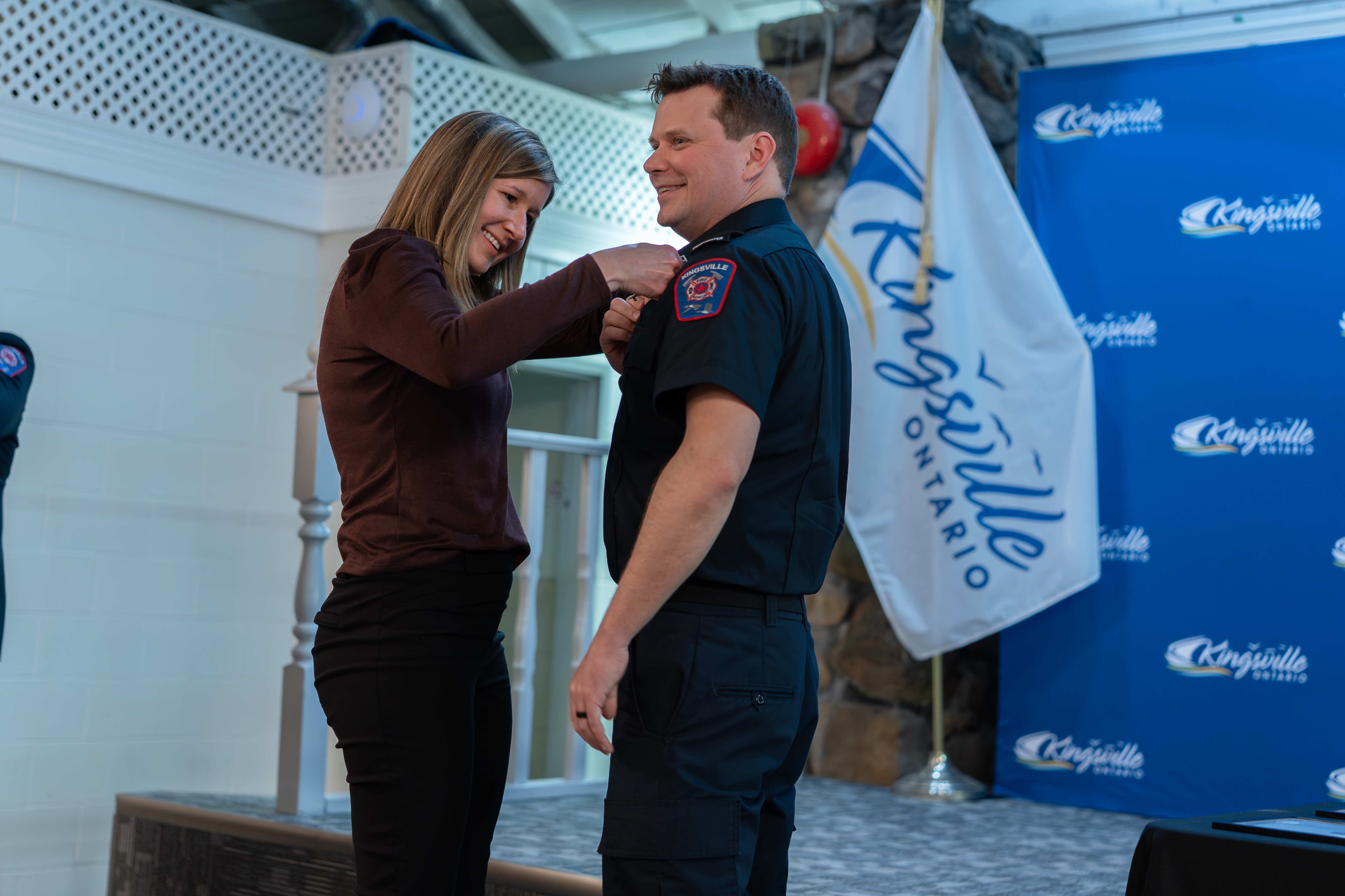 Class of 2024 Fire recruit has badge pinned on his lapel during Badge Pinning Ceremony