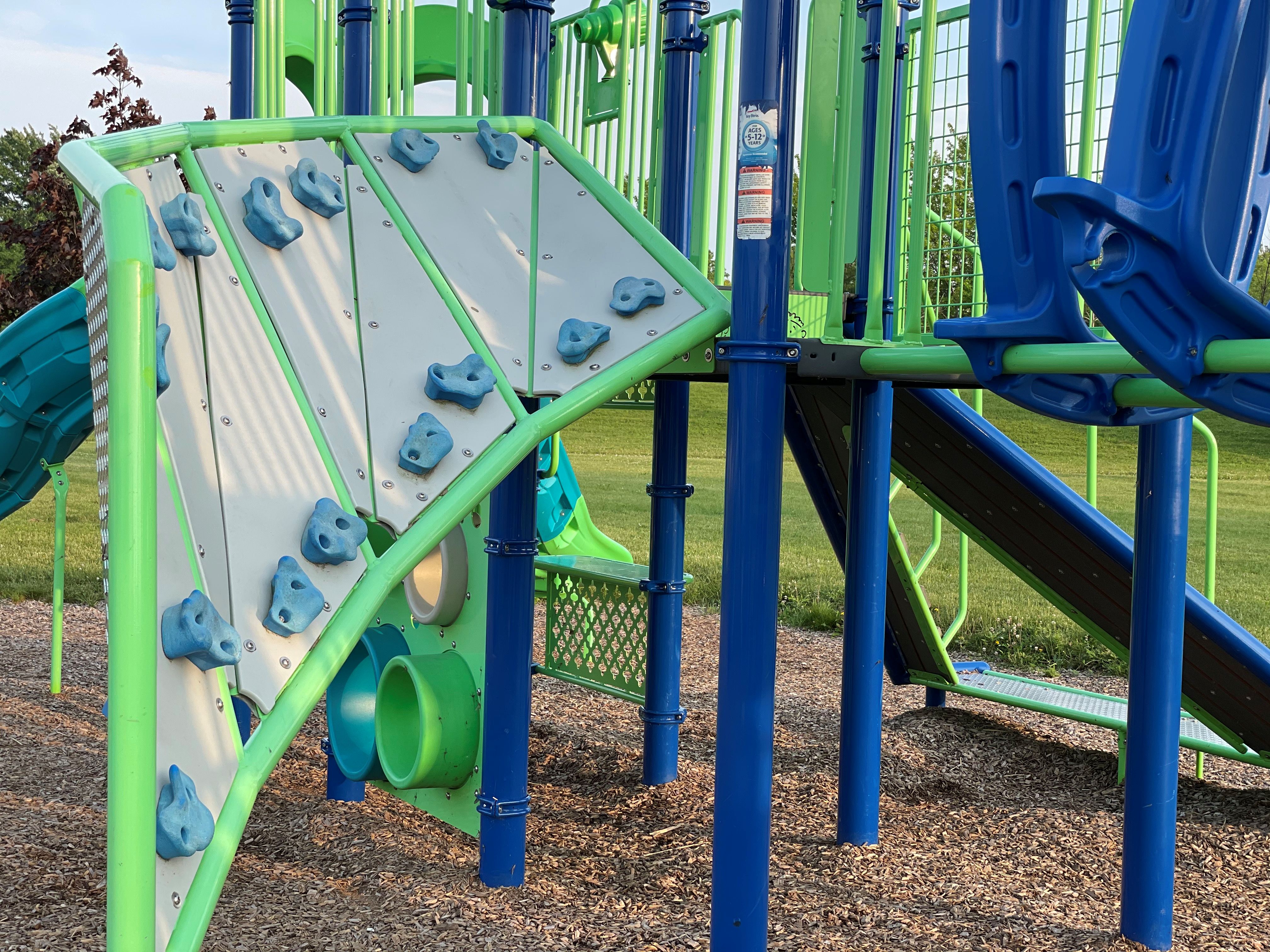 Fun climbing wall playground equipment at a park