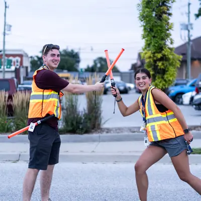 Two young volunteers have a light saber fight