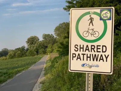 a sign in front of a path that reads "Shared pathway"
