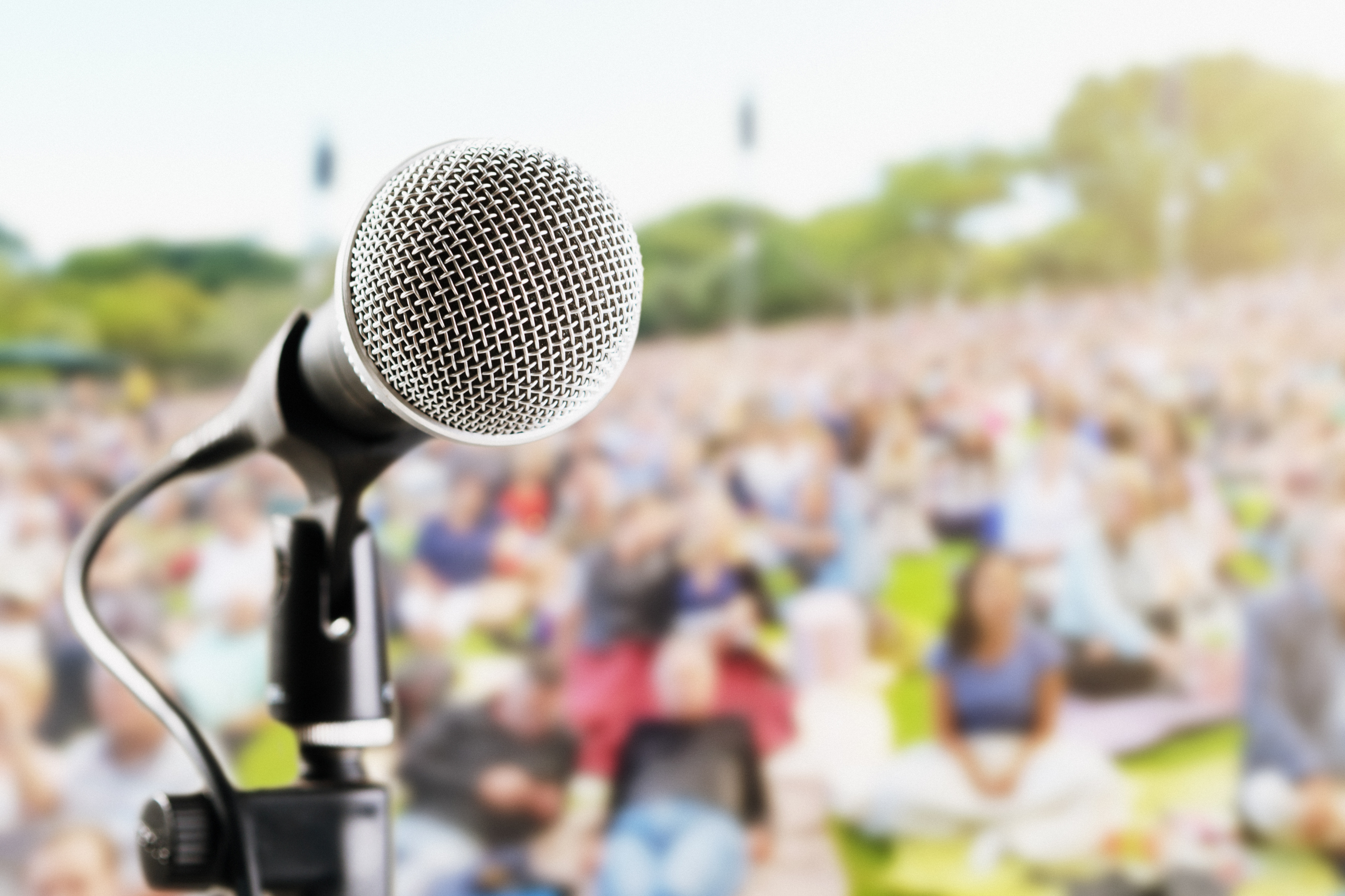 Microphone on stage overlooks outdoor crowd