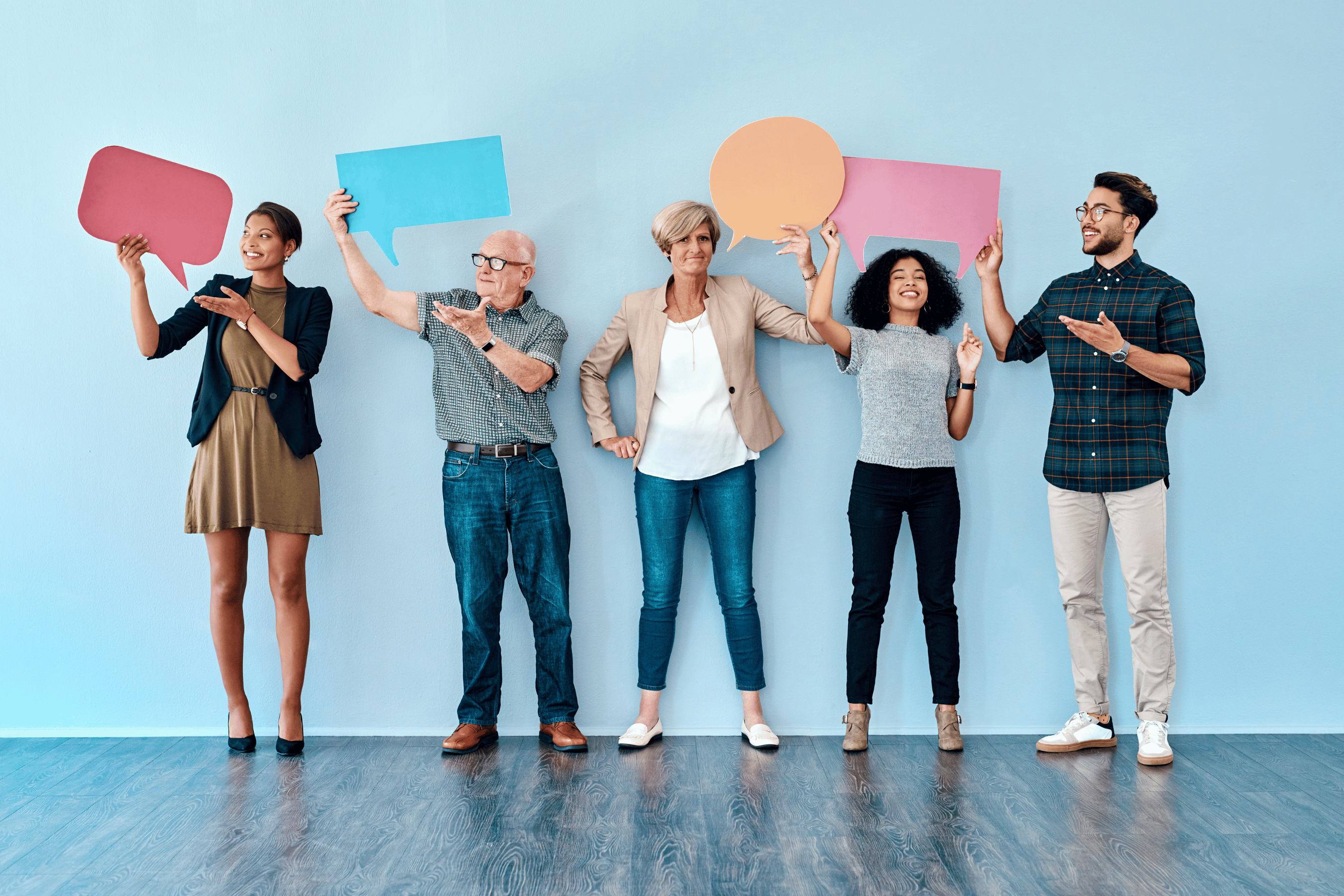 Group of people hold speech bubbles