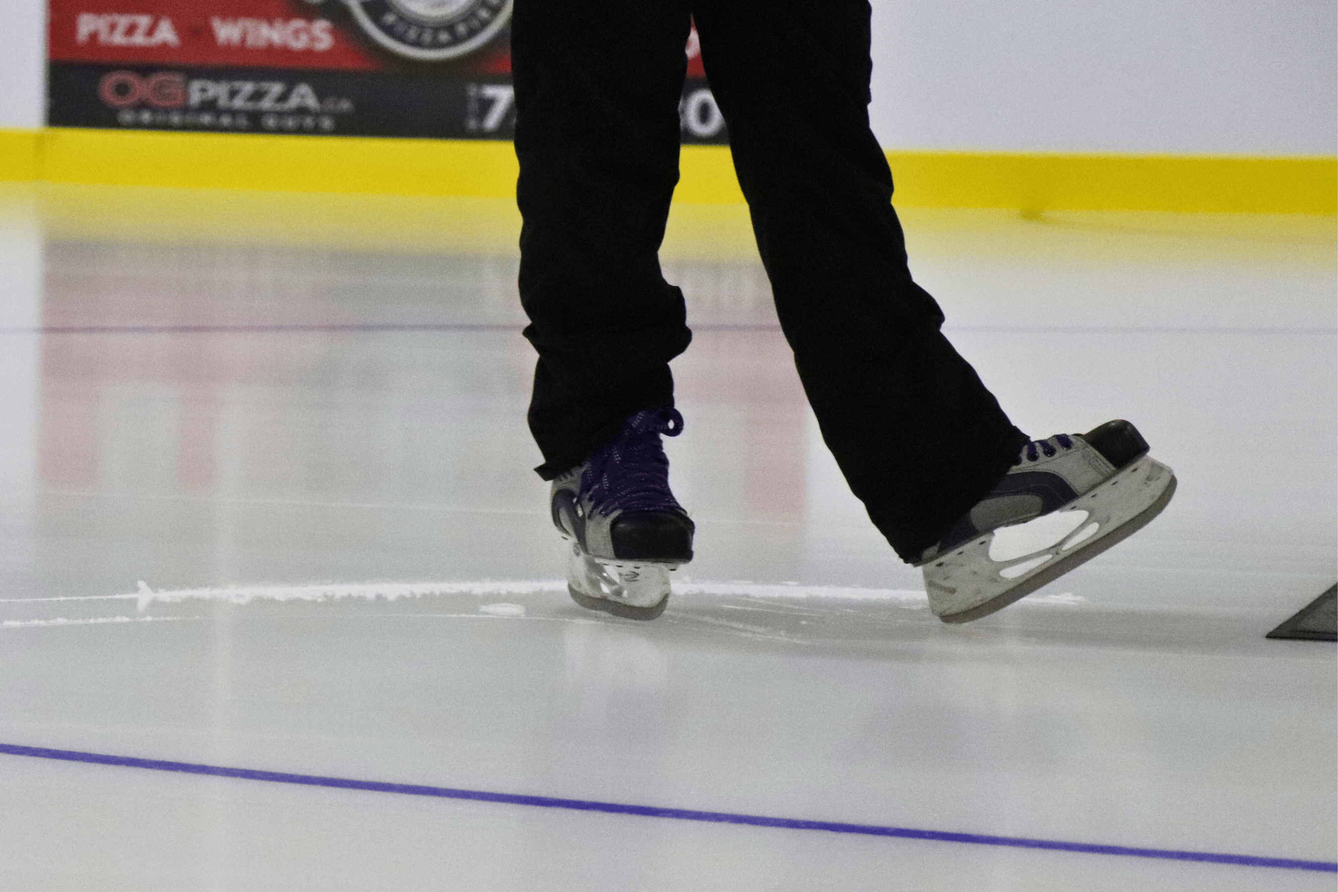 Ice skater glides on ice pad