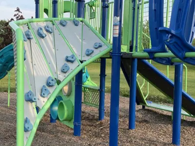 an angled rock climbing wall at a playground