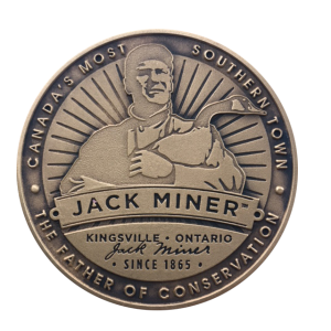 Front of collector coin shows Jack Miner holding a goose