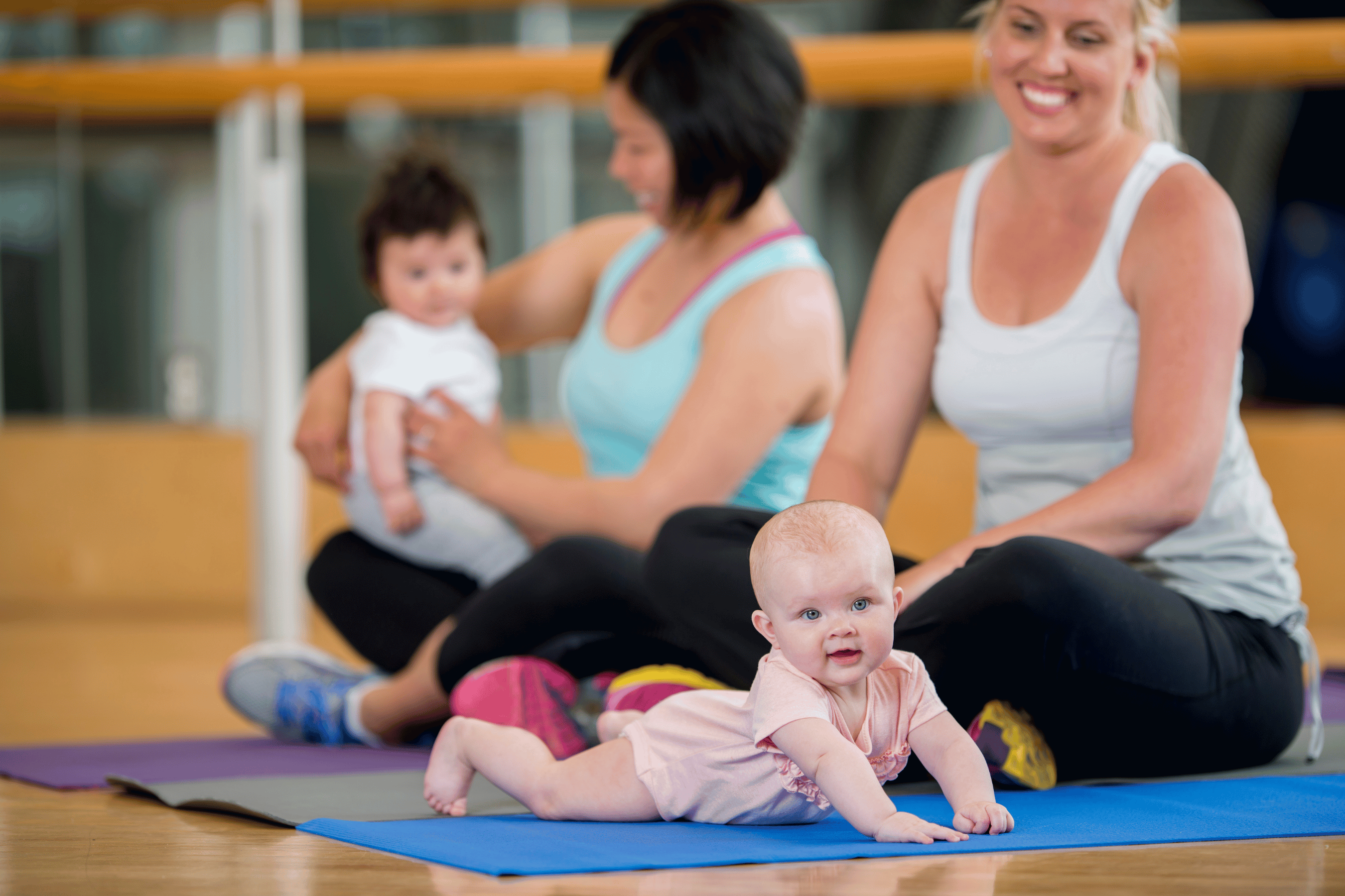New moms join their tots on a gym mat