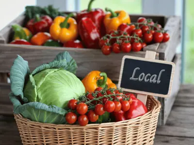 Fresh produce on display with sign that reads "local"