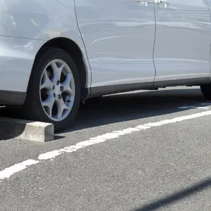 A white car in outdoor parking lot
