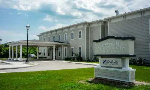 Kingsville's Grovedale Arts & Culture Centre, a large white banquet hall with porch overhang