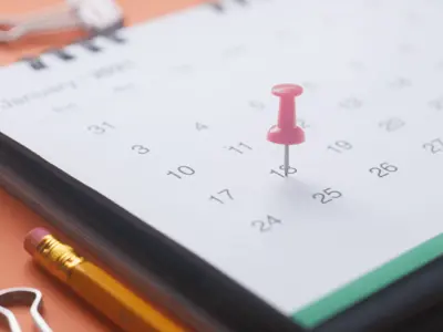 Desk calendar with red pin on date