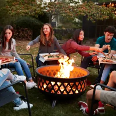 Friends gather around a backyard firepit