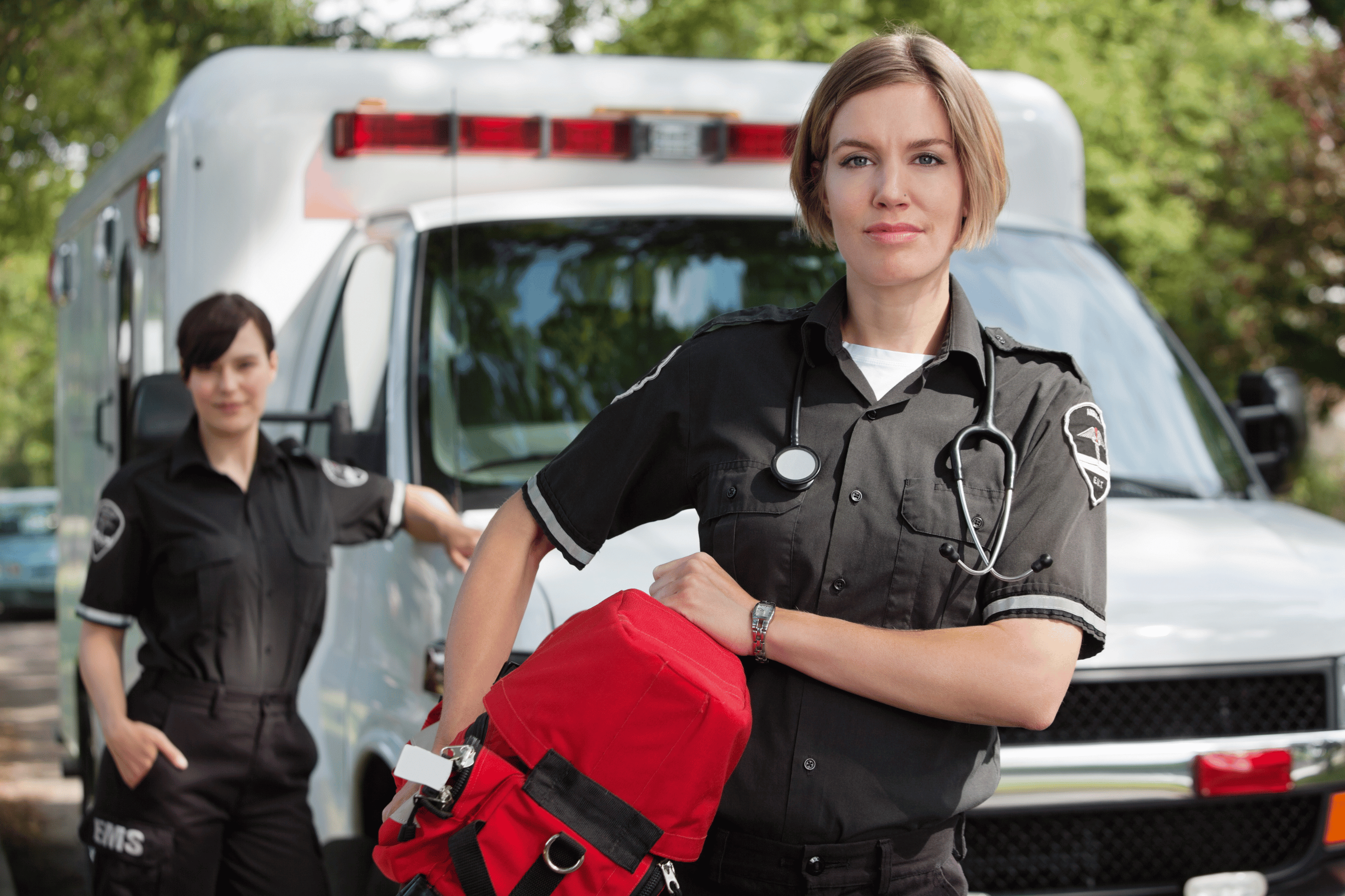 Paramedics carry supplies in from the ambulance