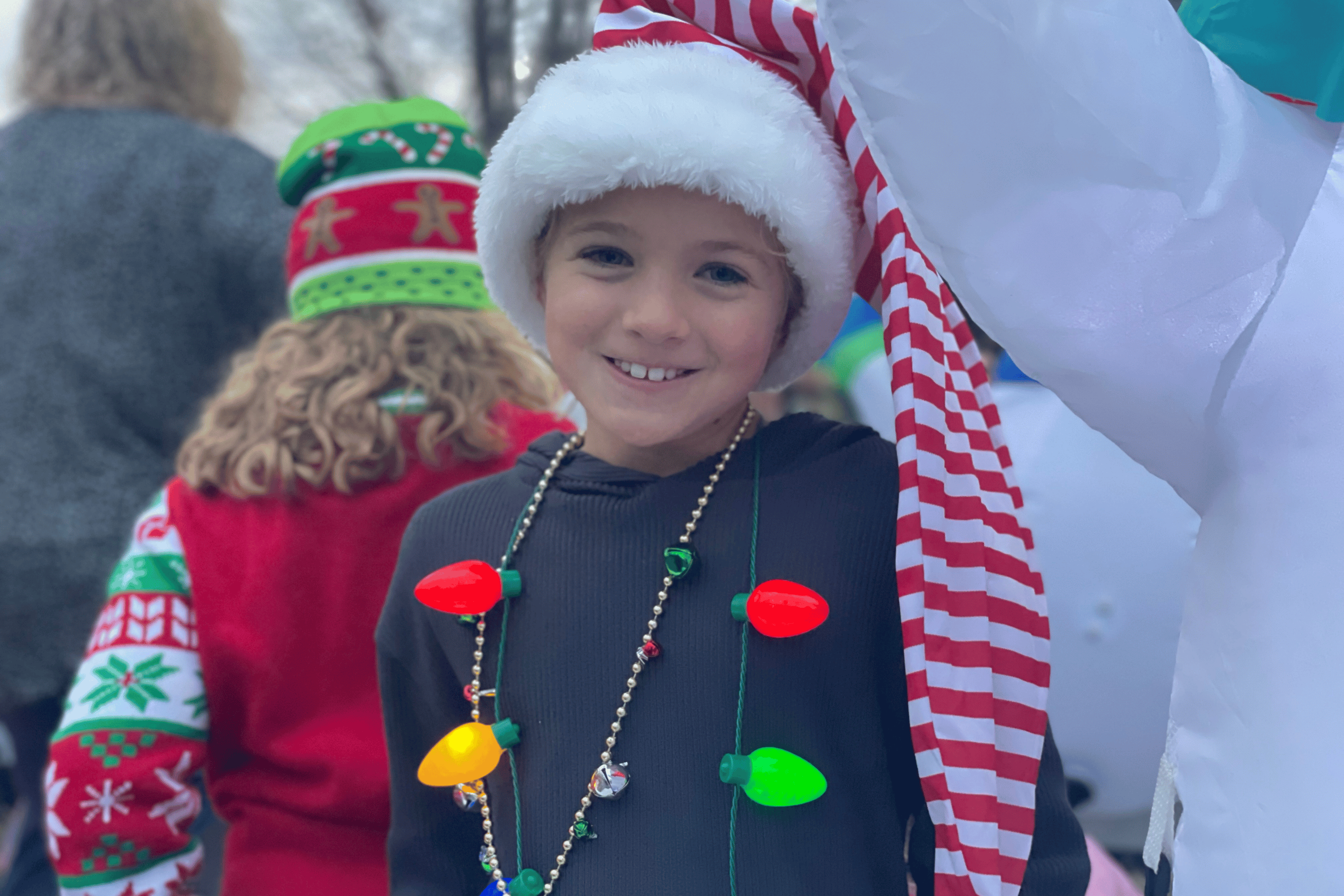 Smiling girl wears Christmas themed accessories